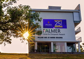 Palmer Center for Chiropractic Research building with 25th anniversary banner