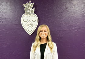 Palmer Florida Intern of the Month November 2020 Rachel Austin in front of Palmer logo.