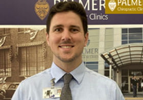 Alexander Cole, intern of the month, standing in front of clinic.