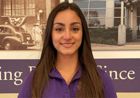 Emily Miller, intern of the month, in front of Palmer building photo