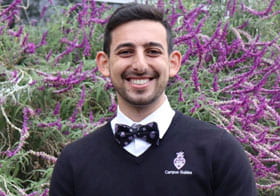 Rami Shnoudi, Palmer West student, smiling and wearing Palmer bow tie.