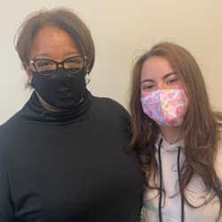 Amber Lynch, Palmer student, and Dr. Teri Payton Dexter (Main, '86) standing side-by-side in masks. 