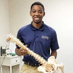 Ben Phillips, Palmer College of Chiropractic student, with model spine.