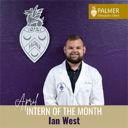 Ian West, Palmer Florida intern, in a white coat in front of purple wall.