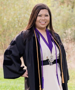Mandy Wong, D.C., smiling in graduation robes and cords.