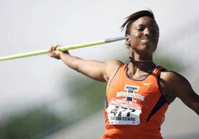 Alecia Beckford Stewart in orange sports shirt throwing a green javelin