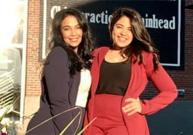 Two sisters smiling in outdoor photo.