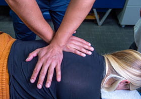 Female student receiving a spinal adjustment.