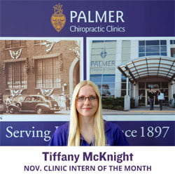 Tiffany McKnight standing in front of Palmer campus picture.