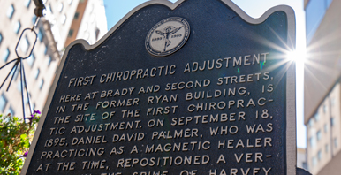 Cropped image of the First Chiropractic Adjustment sign.