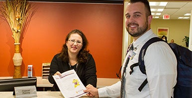 College student talking with a staff member