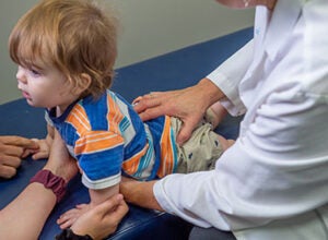 chiropractor examining a toddler's back