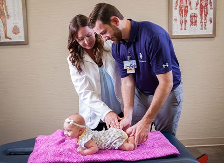 Chiropractor and student intern performing an adjustment