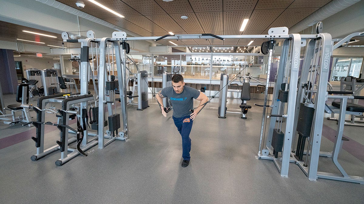 Man using weight machine.