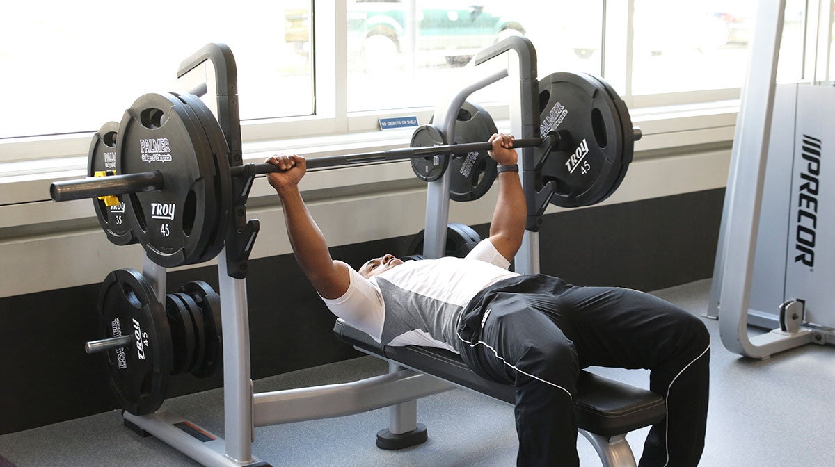 Man lifting bar bell weights.