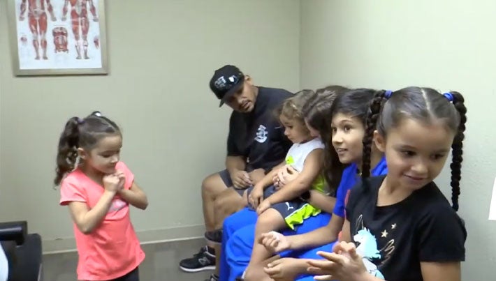 Photo of a chiropractic patient in the office with his family.