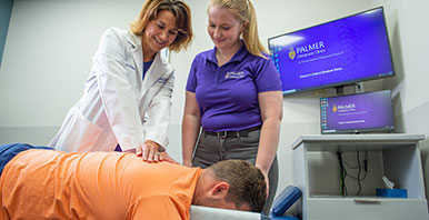 Chiropractor and student intern performing an adjustment