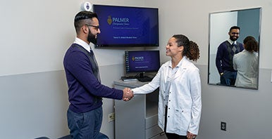 Chiropractic student intern greeting a patient.