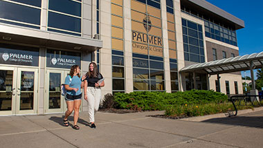 Two people outside the Palmer Chiropractic Clinics in Davenport, Iowa