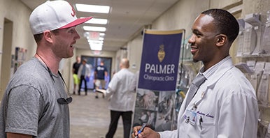 Chiropractic intern greeting a patient