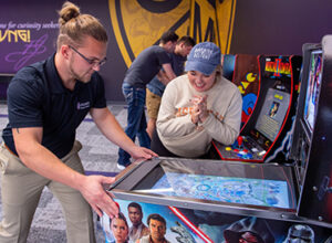 Students playing arcade games in the Student Union.