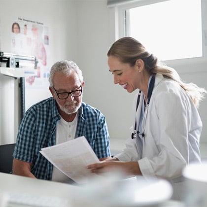 Doctor speaking with patient in exam room.