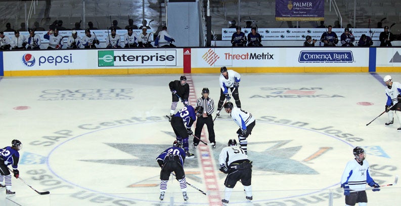 Hockey teams waiting for puck drop.