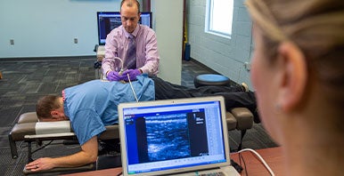 Chiropractors examining a patient's back.