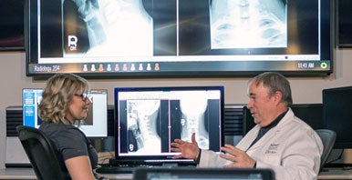 Dr. McLean and student reviewing X-rays.