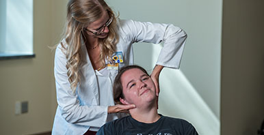 Chiropractor performing an adjustment on a patient.