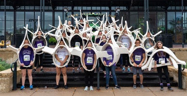 Group of students posing in a spine costume.