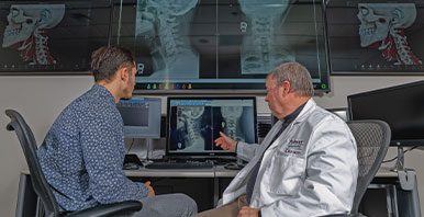 Student and professor reading x-rays.