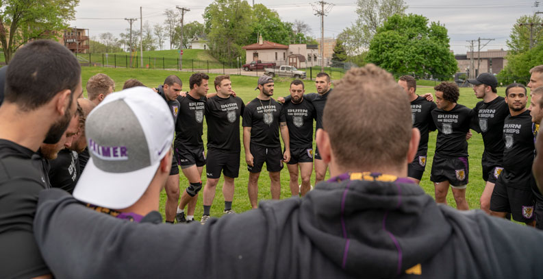 Group of Palmer men's rugby player's in circle
