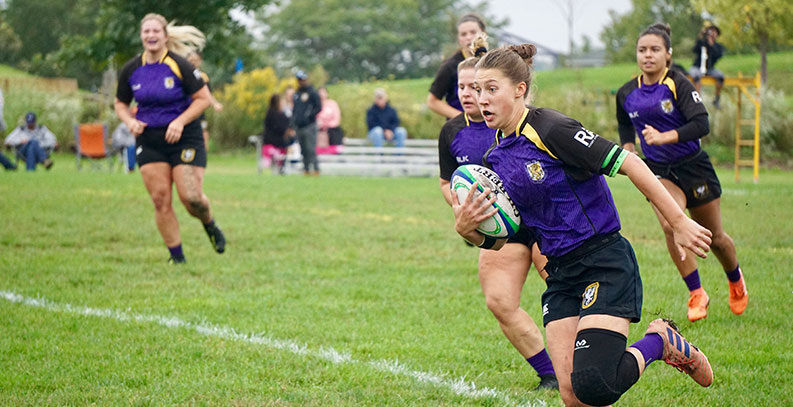 Palmer women's rugby team playing.