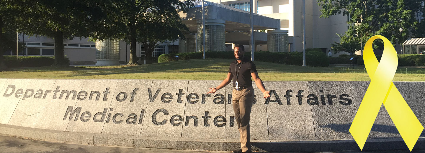 Student standing in front of a Veterans Affair hospital