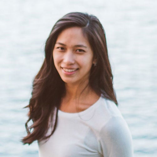 Vivian Ly smiling in front of body of water.