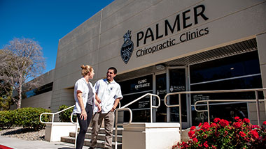 Two student interns standing outside the Palmer Chiropractic Clinics in San Jose, California