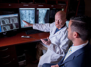 Two chiropractic clinicians reading an X-ray 
