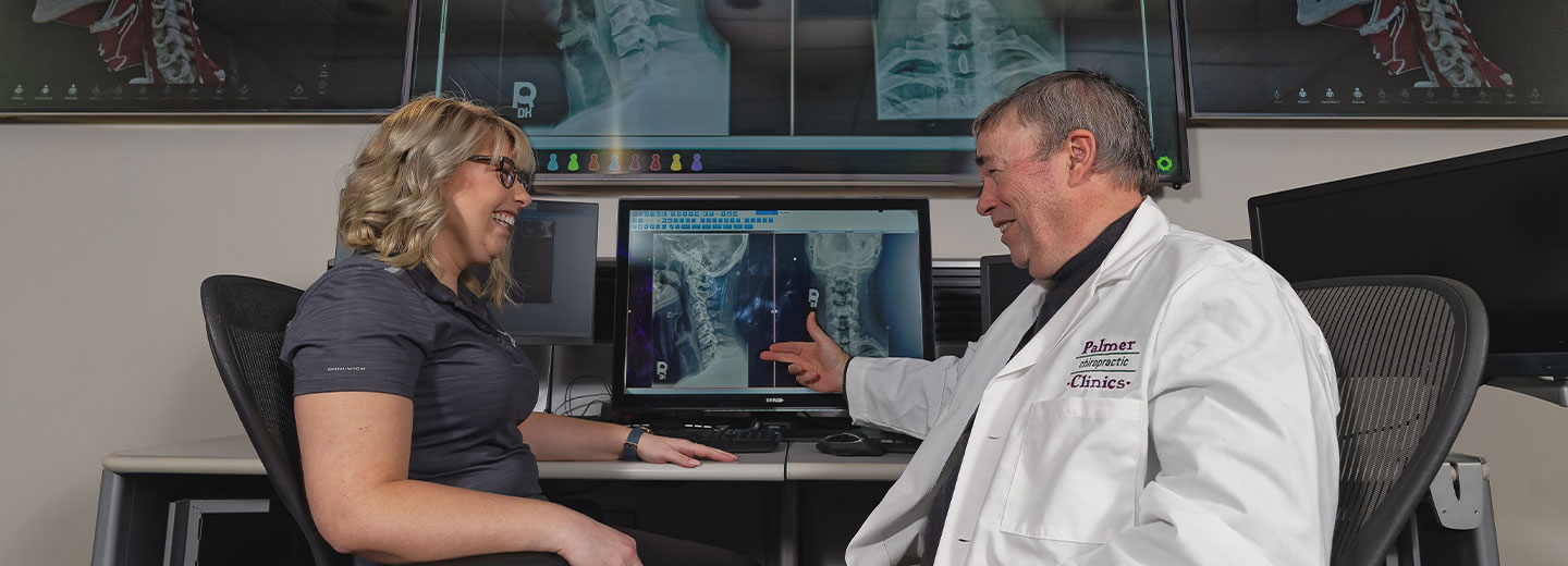 Professor and student in front of radiology images