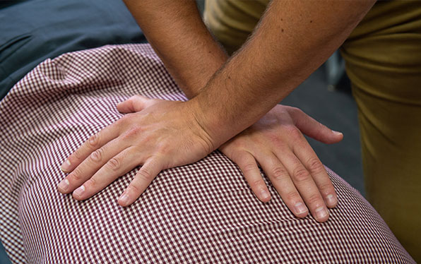 Chiropractor performing a lower back adjustment