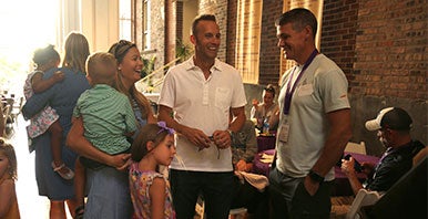 Group of Palmer alumni talking on campus.