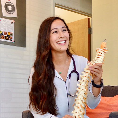 Felisha Truong, D.C. holding a spine model