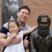 Kilbo Yun and daughter posing with the First Adjustment Statue.