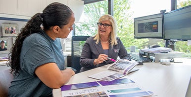 Counselor looking over brochure with student.