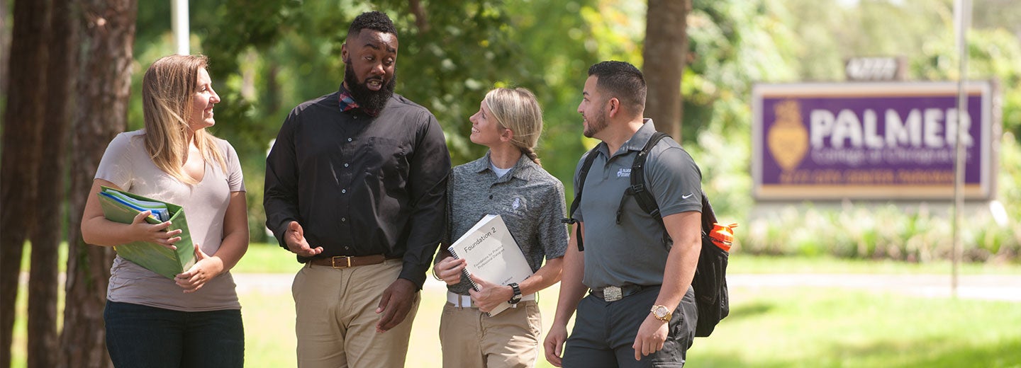 Four students walking outside