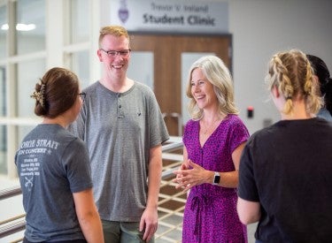 Admissions counselor speaking with group of prospective students