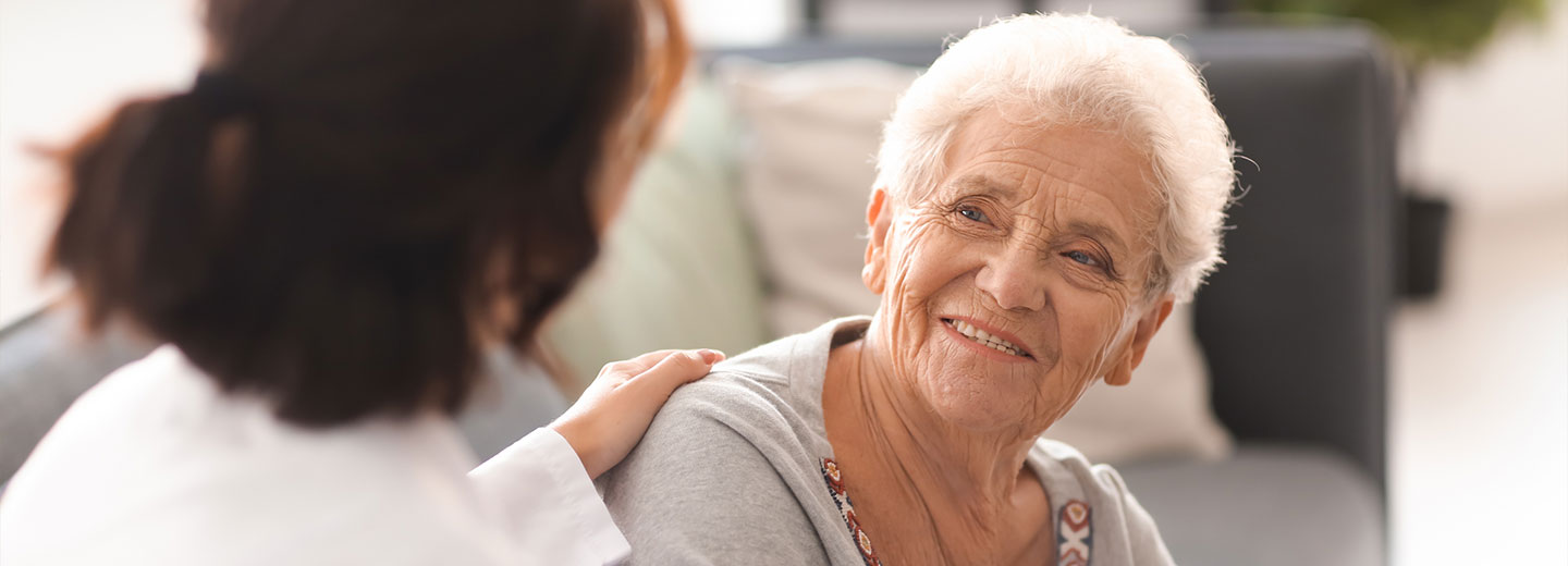 Provider speaking with elderly patient.