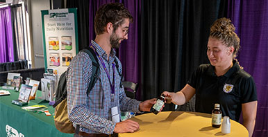 Two people talking at a tradeshow booth