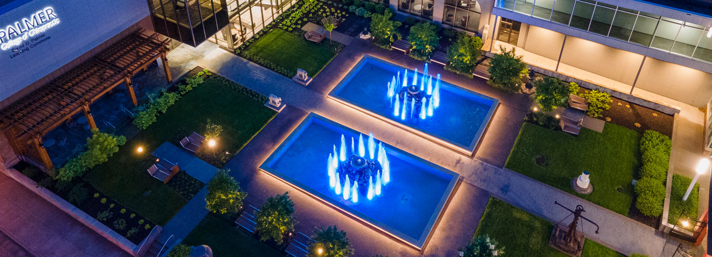 Photo of Palmer College fountains at night.
