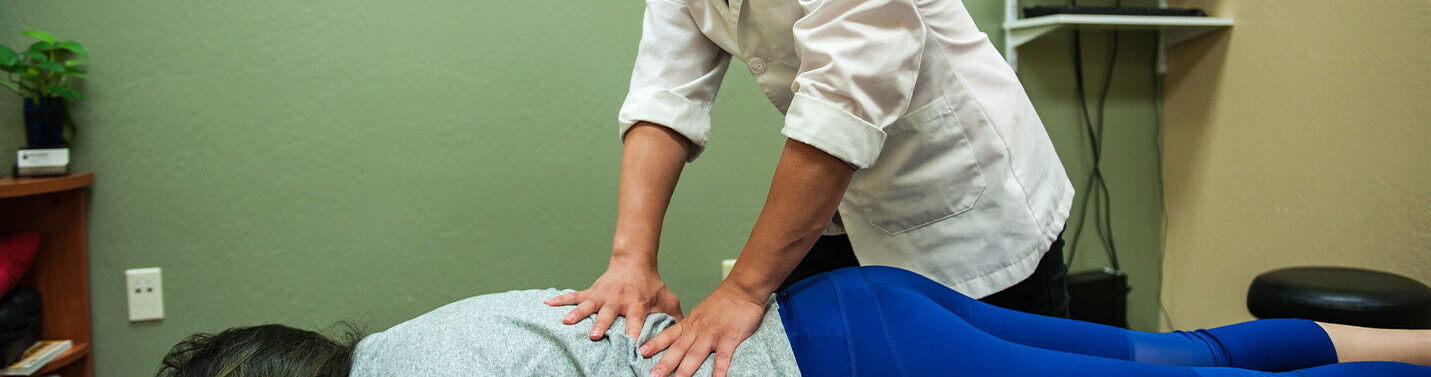 Chiropractic intern examining a patient.
